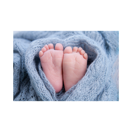 Baby feet wrapped in a blue blanket